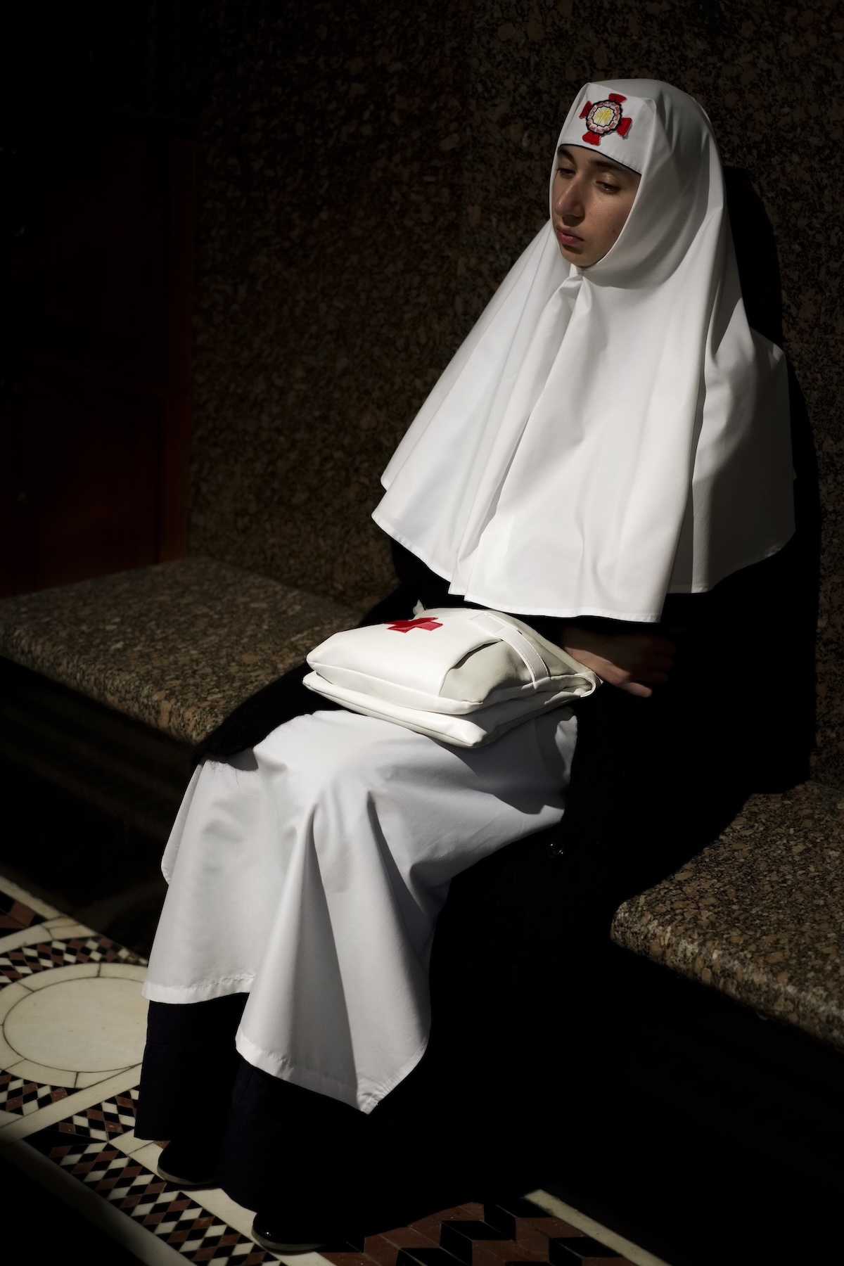 A pensive nun sits in the Sepulchre church in the Christian quarter of Jerusalem during Holy Week